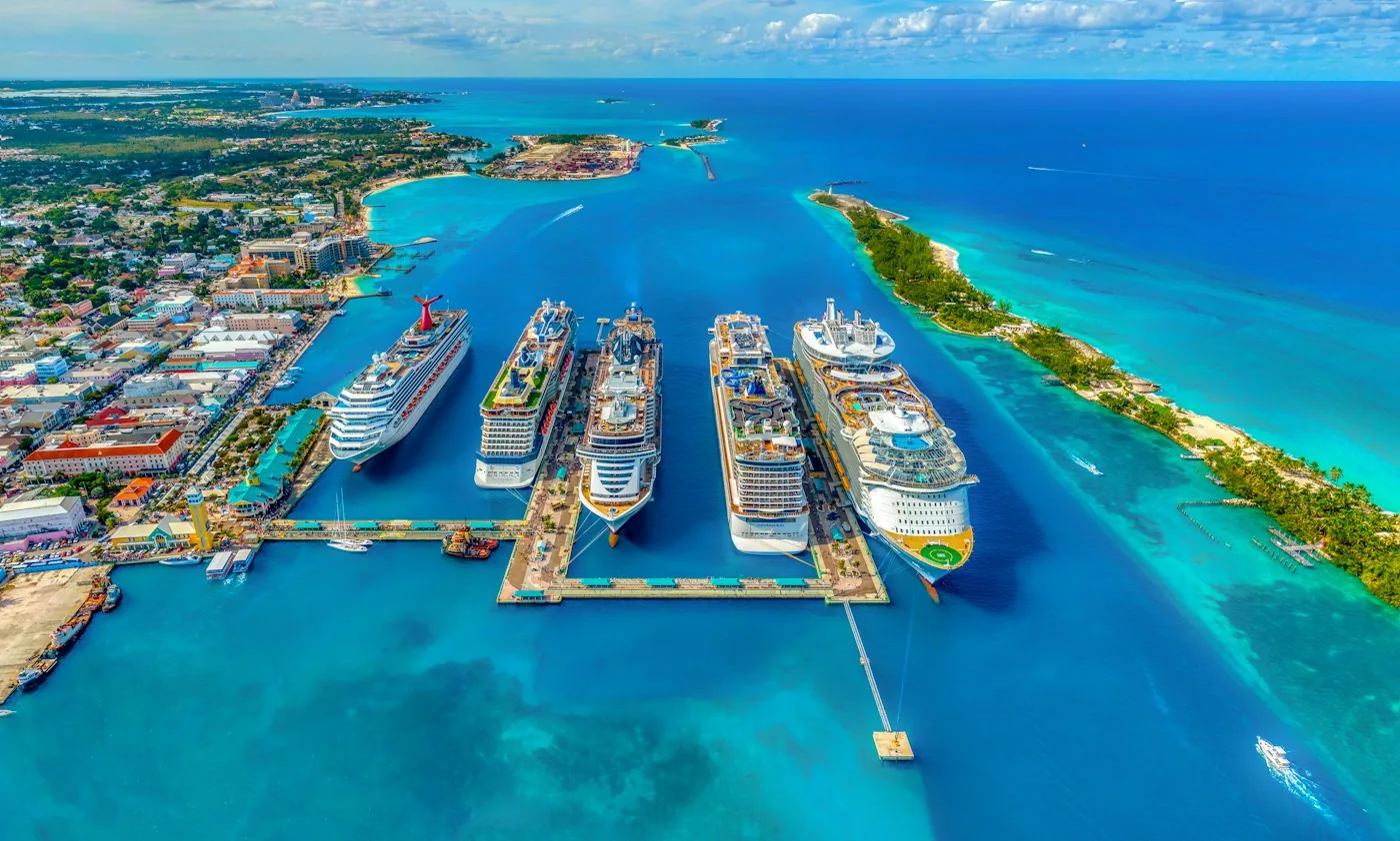 Real aerial photograph of cruise ships beside bright turquoise water in Nassau harbour