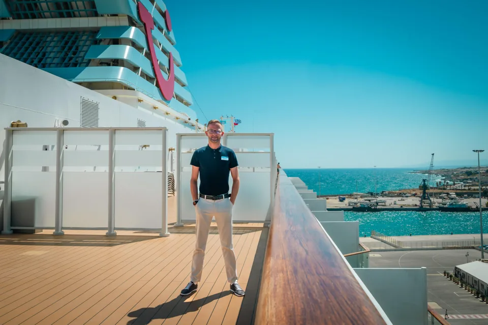Marella's cruise director pictured on an outdoor deck in the original TUI announcement