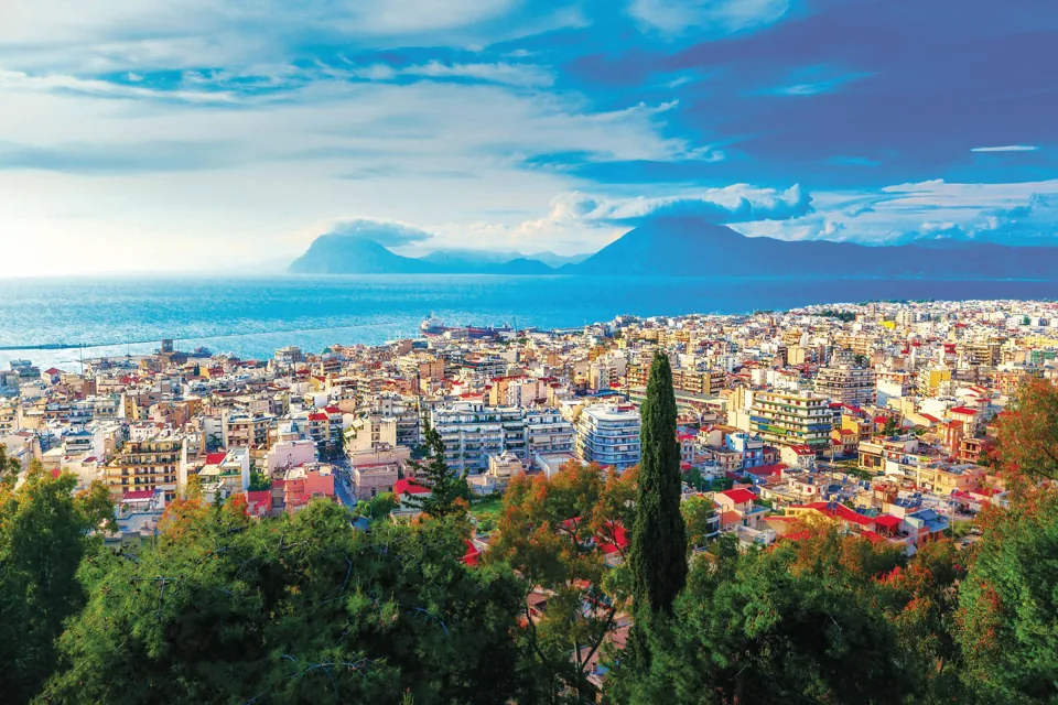 A panoramic photograph of Patras with the Gulf of Patras and mountains beyond